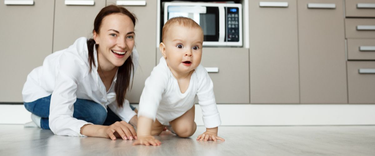 Mother child playing kitchen floor having fun (2)